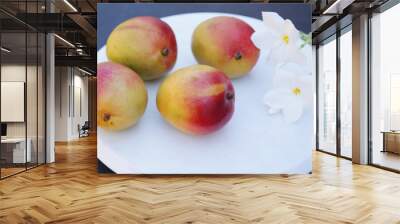 red and yellow ripe organic mango fruit on white with white flowers. Tropical fruit concept. Wall mural