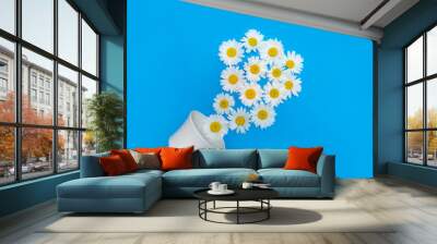 Chamomile in a cup Chamomile natural soothing Tea Natural Medicine Alternative medicine Cleansing, antibacterial hemeopathic remedy flowers and plants. Daisies fall out of the cup Wall mural