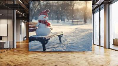 A cheerful snowman sits on a wooden bench in a snowy park. The warm sunlight filters through the trees, creating a magical winter scene. A perfect reminder of holiday joy. AI Wall mural