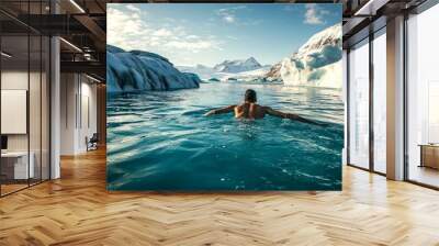 A person swims in icy blue waters surrounded by majestic icebergs. The beautiful landscape captures the essence of adventure and freedom. A stunning nature scene in a serene environment. AI Wall mural