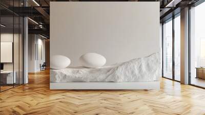 A serene arrangement of two smooth white eggs resting on a textured white stone. The minimalist style evokes calmness and simplicity. Perfect for modern decor or wellness themes. AI Wall mural