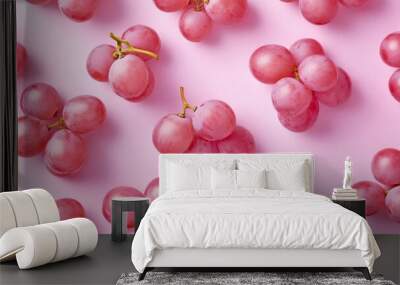 Fresh and juicy pink grapes scattered on a soft pink background. This image captures the natural beauty of fruits. Ideal for healthy lifestyle themes and food photography. AI Wall mural