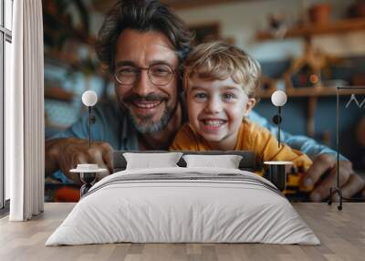 Joyful father and son playing with toy train at home Wall mural