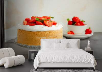 Angel food cake with whipped cream and slices of fresh strawberries on top on a concrete background. Summer dessert. Horizontal orientation, copy space. Wall mural