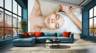 Woman in mask on face in spa beauty salon Wall mural