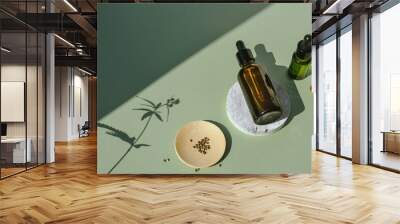 Glass bottles with oil and tincture of CBD and marijuana branch shadow Wall mural