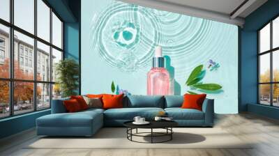 Moisturizing cosmetic products on water with drops. Serum glass bottle and cream jar on aqua surface with waves in sunlight. Concept for advertising organic moisturizing skin care, spa. Wall mural