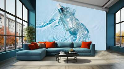 Serum, essence with collagen in transparent bottle with a pipette on water blue background Wall mural