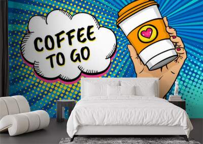 Pop art background with female hand holding bright travel coffee mug and speech bubble with Coffee to go text. Vector colorful hand drawn illustration in retro comic style. Wall mural