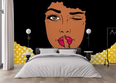 Pop art face. Young sexy african american woman holds index finger at the mouth as silence sign and winks on dots background. Vector illustration in retro comic style. Holiday party invitation poster. Wall mural