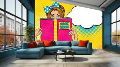 Wow female face. Sexy young woman housewife with wide open eyes and bow on her head holding big Cook Book. Vector colorful background in pop art retro comic style. Party invitation poster. Wall mural