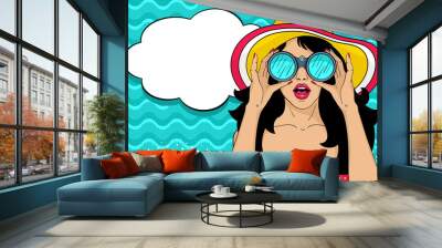 Wow pop art female face. Sexy surprised girl in hat with open mouth holding binoculars in her hands and speech bubble. Vector colorful summer background in pop art retro comic style. Wall mural