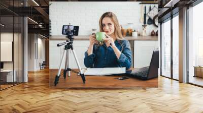 Pregnant girl works at home in self-isolation mode in quarantine and records videos Wall mural