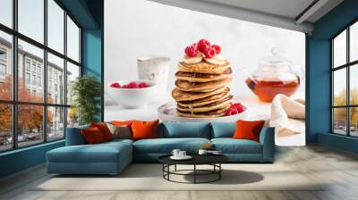 Stack of homemade pancakes with fresh raspberries on light concrete background Wall mural