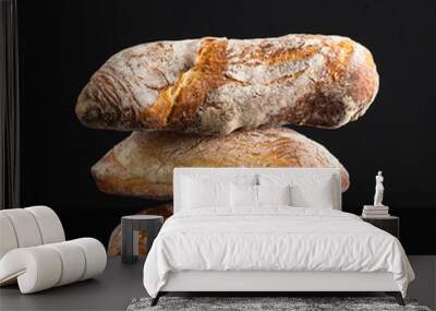 a pile of fresh Italian bread on black background Wall mural