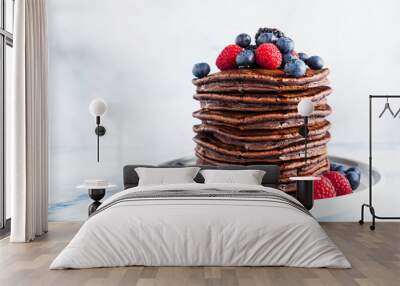 a stack of chocolate gluten free pancake with fresh berries. morning healthy breakfast Wall mural