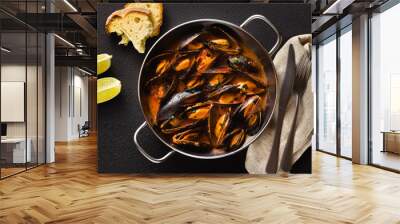 freshly cooked mussels in a frying pan in tomato sauce. pepata di cozze or mussels marinara. classic dish of mediterranean italian cuisine. on black background Wall mural