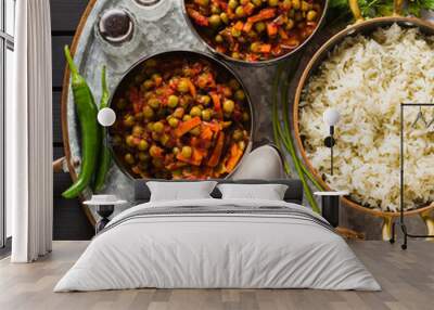 vegan curry with green peas and basmati rice served on a wooden table tray, healthy Indian comfort food Wall mural