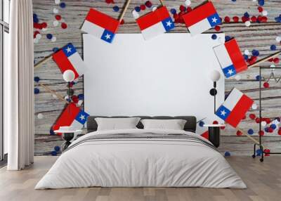 September 18, happy independence day of Chile. memorial day for independence. the concept of patriotism. mini flags and confetti on white wooden background with white paper sheets Wall mural