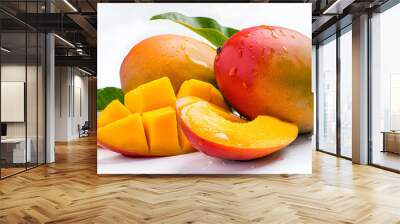 Two ripe mangoes and one-half mango with leaves on a white background in display style. Wall mural