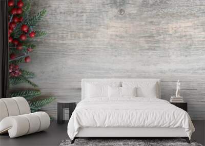 Christmas Holiday Evergreen Pine Branches and Red Berries Over Wood Background, Copy Space Wall mural