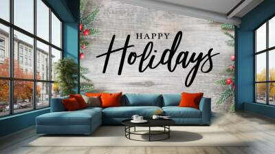 Happy Holidays Text with Holiday Evergreen Branches and Red Berries Frame on Sides Over Rustic Wooden Background Wall mural