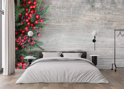 Holiday Evergreen Branches and Berries Over Rustic Wood Background Wall mural