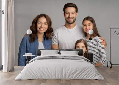 Portrait of happy family father, mother and kids isolated on simple gray background Wall mural