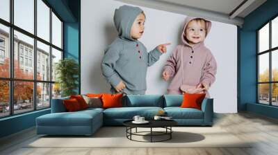 Baby fashion. Unisex gender neutral clothes for babies. Two Cute baby girls or boys in cotton set Wall mural