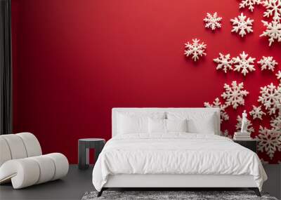 Group of white snowflakes on a red background, symbolizing the festive and cold winter season Wall mural