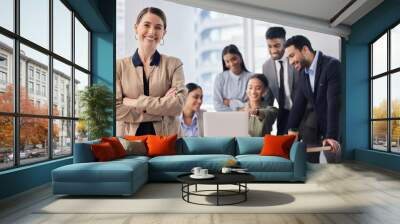 Here to help them succeed. Shot of a young businesswoman at work. Wall mural