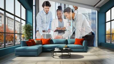 A tech-focused team. Shot of a group of businesspeople brainstorming and exchanging ideas in a modern office. Wall mural