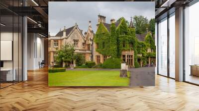 CHIPPENHAM, UK - AUGUST 9, 2014: Castle Combe, unique old English village. Old house and park Wall mural