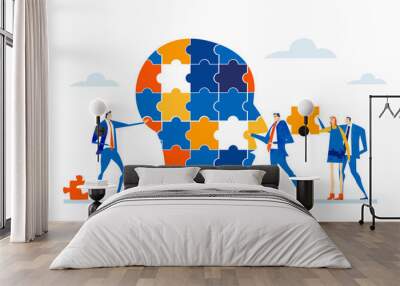 Hand of businessman places puzzle piece in human's head.  Wall mural