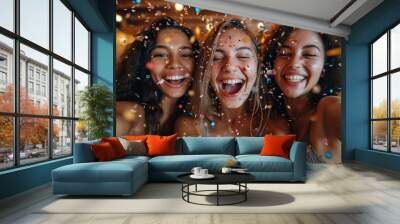 Portrait of smiling young women on party making selfie with confetti. Wall mural