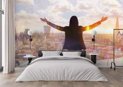 Young woman looking over the City of London at sun set. Future, new business opportunity and business success concept. Wall mural