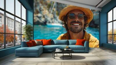 A cheerful and stylish young man poses for a summer portrait on the beach, exuding confidence and relaxation. Wall mural