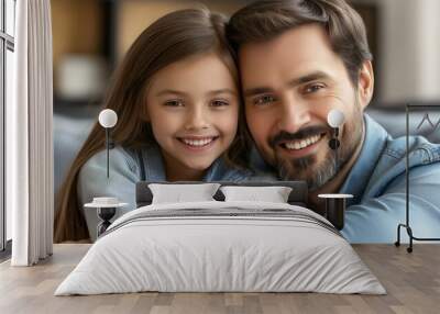 A man and a little girl are sitting on a couch, smiling at the camera. Scene is warm and happy, as the two are enjoying each other's company Wall mural