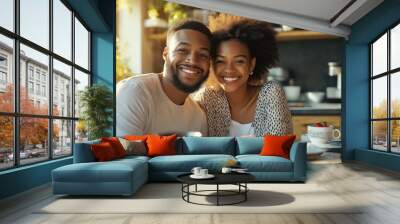 A man and woman are smiling at the camera in a kitchen. They are posing for a picture with a plate of food in front of them Wall mural