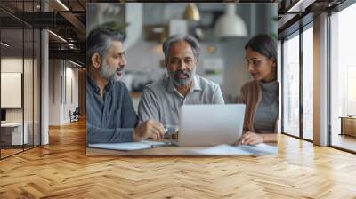 A professional Indian businessman leads a meeting with colleagues discussing finance strategies. Wall mural