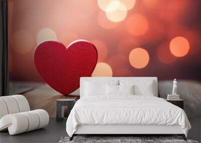 A vibrant and glowing red heart-shaped symbol on a festive background with bokeh lights. Wall mural