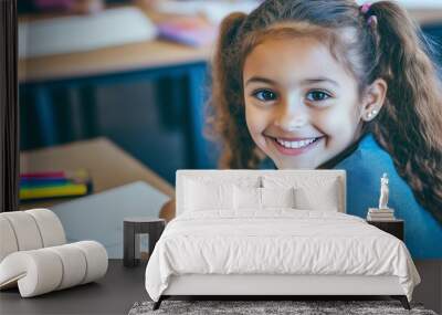 A young girl is sitting at a desk with a piece of paper in front of her. She is smiling and holding a crayon Wall mural