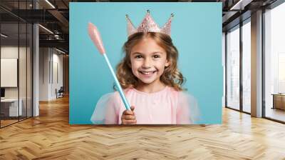 Adorable little girl in a cute princess dress radiating happiness and joy at a holiday celebration. Wall mural