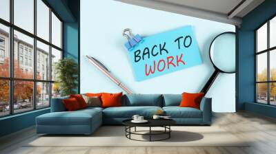 BACK TO WORK text written on a sticky with magnifier and pen, business concept Wall mural