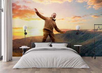 Bearded Man reaching the destination  and on the top of mountain  at sunset on autumn day  Travel  Lifestyle concept The national park Lake District in England Wall mural