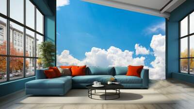 Blue sky with white curly clouds Wall mural