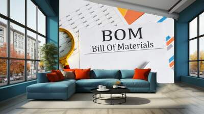 BOM - Bill Of Materials text with magnifying glass lens on the office desk table. Wall mural