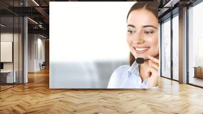 Brunette female customer service representative in a headset is consulting clients online. Call center and business people concept Wall mural