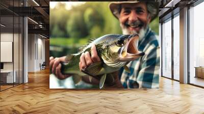 Close-up of a smiling angler holding a caught perch in his hands Wall mural