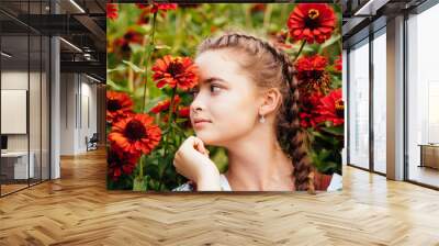 Close up portrait of sad teenager girl with cute two braids around the flowers in the garden. Eco sustainable ecology mental health concept. Wall mural